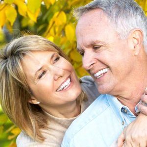 middle aged couple smiling at each other outside